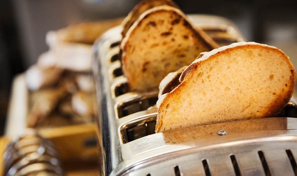 A loaf of bread being wrapped in aluminium foil for freezing