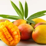 A ripe Alphonso mango, known as the "King of Mangoes," with a vibrant yellow color and a slight green blush.